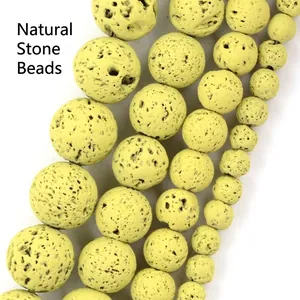 Macro view of yellow natural lava stone round beads with porous texture for jewelry making