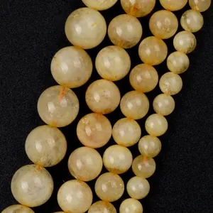 Detailed macro shot of yellow natural stone round beads showing unique internal textures