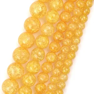 Macro view of yellow natural stone beads showing detailed interior crackle texture and gloss.