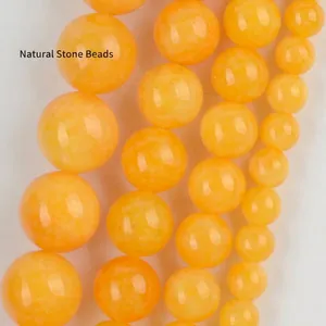 Close-up macro view of polished yellow natural stone round beads for jewelry making