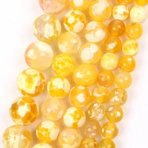 Close-up detail of yellow natural stone round beads with unique dragon vein patterns