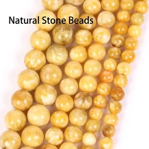 Macro view of polished yellow natural stone round beads for handmade jewelry making