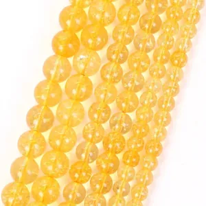 Macro detail of yellow natural stone round beads showcasing natural internal textures