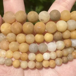 Macro detail view showing texture of natural yellow stone round beads for jewelry making
