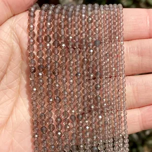Close-up of small faceted smoky grey natural stone beads for DIY jewelry making.