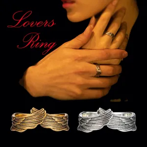 Detailed view of retro angel wing adjustable couple rings in gold and silver