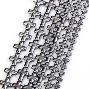 Close-up macro view of high-quality natural faceted hematite cross beads for DIY jewelry design
