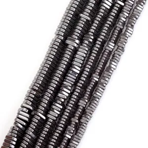 Macro view of metallic black natural hematite triangular spacer beads for DIY jewelry