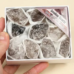 Detailed macro view of natural smokey quartz raw mineral stones in a white gift box packaging