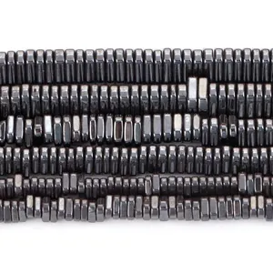 Close-up view of metallic black natural hematite triangle spacer beads for DIY jewelry making