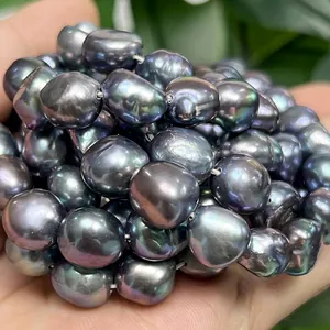 Close-up of peacock black baroque pearls showing metallic luster and irregular shape.