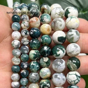 Close-up of green and white dragon vein fire agate beads showing natural textures