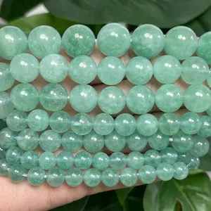 Close-up of polished natural green angelite round stone beads for DIY jewelry making