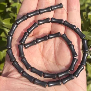 Detailed close-up of 5x12mm black bamboo shaped natural stone beads for DIY jewelry making