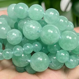 Macro view of high-quality polished light green angelite stone beads for DIY jewelry making