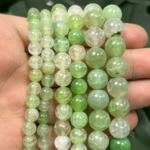Macro view of green dragon vein fire agate round beads showing unique cracked textures