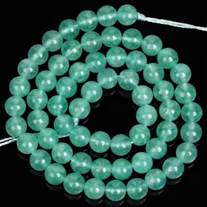 Macro detail view of natural translucent green angelite round beads for DIY jewelry making