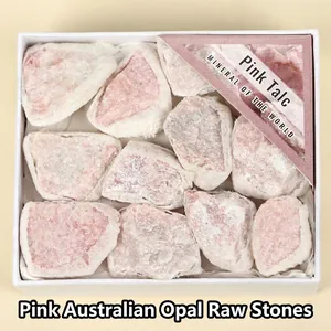 Close-up view of natural raw pink opal mineral stones in a white gift box packaging
