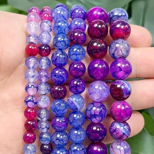 Macro view of various colorful dragon vein fire agate beads in 6mm, 8mm, and 10mm