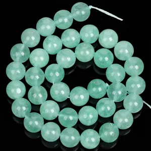 Macro detail of natural light green angelstone round beads for DIY jewelry making