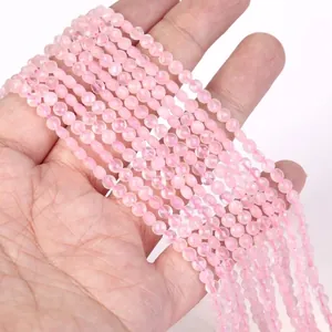 Macro detail of 4mm faceted pink natural stone beads held in hand for jewelry DIY