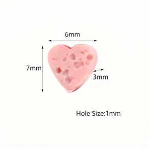 Detailed size view of heart-shaped pink lava rock bead for jewelry making