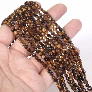 Close-up of 4mm faceted tiger's eye disc beads for DIY jewelry making on a strand