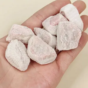 Detail view of natural Australian opal raw stones held in palm for size reference