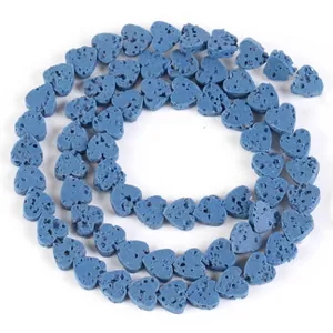 Close-up macro view of blue heart-shaped lava stone beads for DIY jewelry making