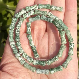 Detailed macro shot of 5x12mm natural green bamboo-joint stone beads for jewelry DIY