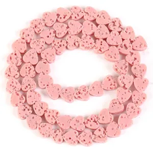Detailed close-up of pink heart-shaped natural volcanic lava stone beads for DIY jewelry