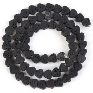 Close-up of heart-shaped natural black lava stone beads for DIY jewelry making.