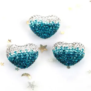 Close-up detail of gradient blue and white rhinestone heart Shamballa beads for DIY jewelry