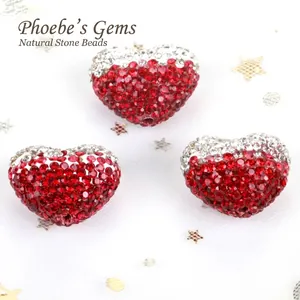 Close-up of red and silver heart-shaped Shamballa rhinestone beads for DIY