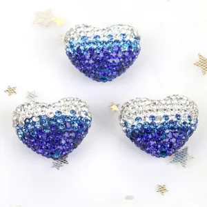 Detailed view of gradient blue heart-shaped Shamballa beads with shiny rhinestones