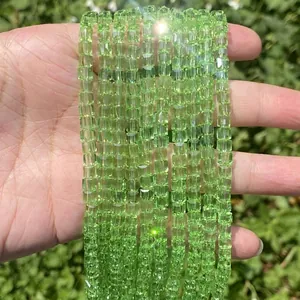 Detailed view of sparkling faceted lime green cube crystal glass beads for DIY jewelry