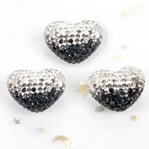Close-up macro view of gradient black and white rhinestone heart-shaped Shamballa beads