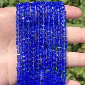Detailed view of faceted square blue crystal glass beads for DIY jewelry making.