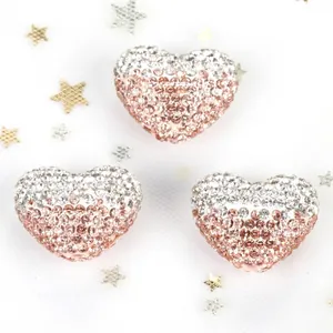 Macro detail of gradient heart-shaped pave beads for DIY phone chains and jewelry
