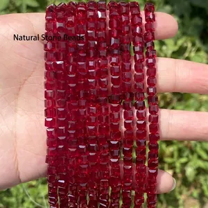 Close-up of faceted square red crystal glass beads for DIY jewelry making materials.