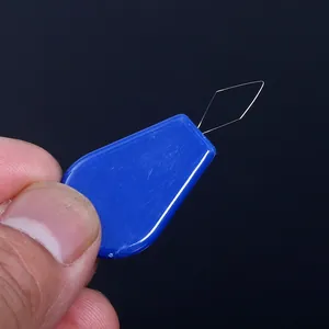 Close-up macro detail of a blue plastic needle threader showing its thin copper wire loop