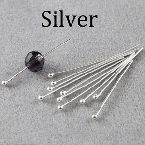 Silver ball head pins for DIY jewelry making shown with a purple faceted crystal bead