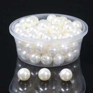 Close-up of ABS imitation pearls with double holes for DIY jewelry making and crafts
