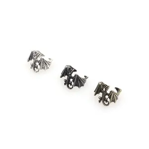 Detailed view of vintage punk style dragon rings in silver black and antique bronze finishes