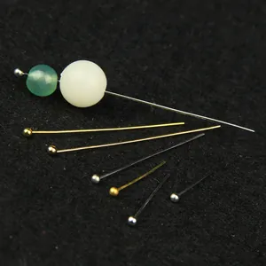 Close-up of DIY jewelry ball head pins in gold and silver finishes