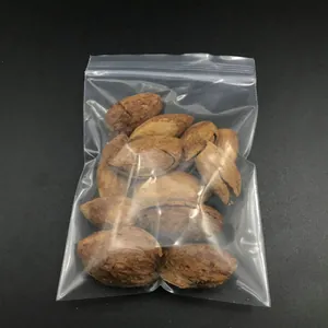 Close-up of clear plastic self-sealing PE bag containing nuts on a dark background