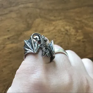 Retro punk style dragon wrap ring with detailed wings in antique silver finish.