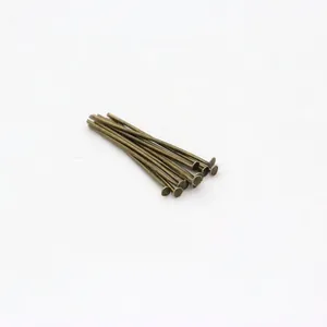 Detail view of bronze-finish metal T-head pins for handmade DIY jewelry crafting