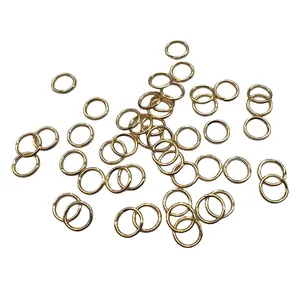 Close-up view of numerous rose gold open jump rings used for DIY jewelry making crafts