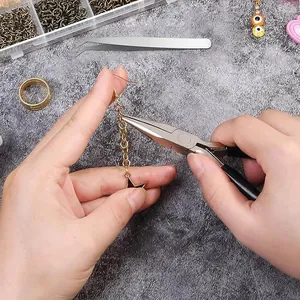 Detailed view of DIY jewelry making with open jump rings and pliers tool